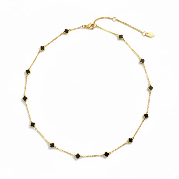 Gold-toned necklace featuring a delicate colored clover pendant, suspended on a fine chain for a soft pop of charm and color.