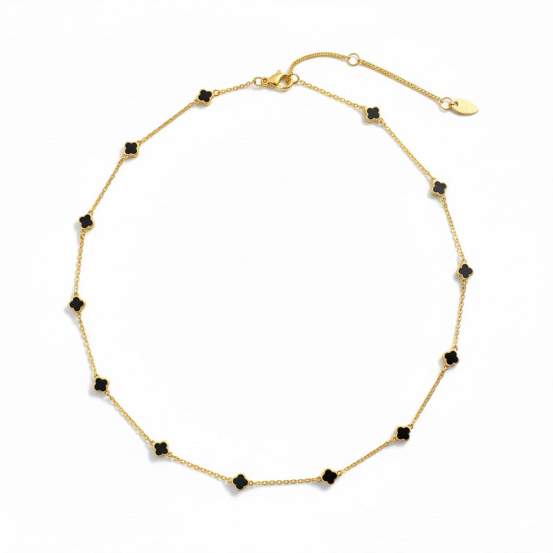 Gold-toned necklace featuring a delicate colored clover pendant, suspended on a fine chain for a soft pop of charm and color.