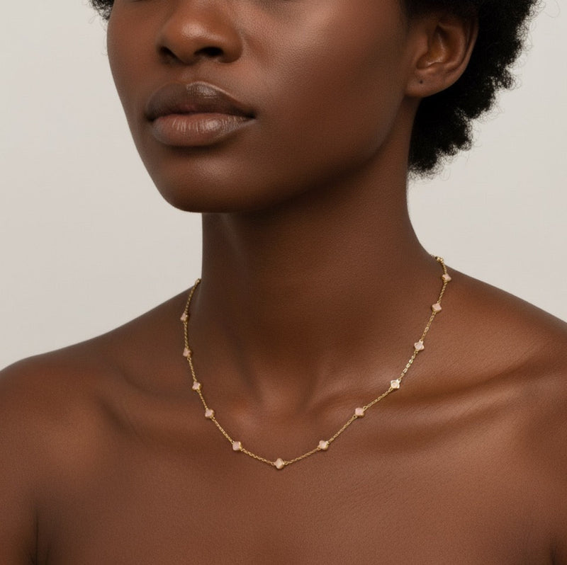 Gold-toned necklace featuring a delicate colored clover pendant, suspended on a fine chain for a soft pop of charm and color.