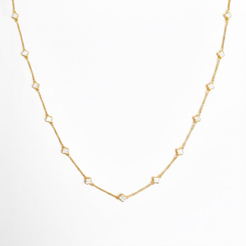 Gold-toned necklace featuring a delicate colored clover pendant, suspended on a fine chain for a soft pop of charm and color.