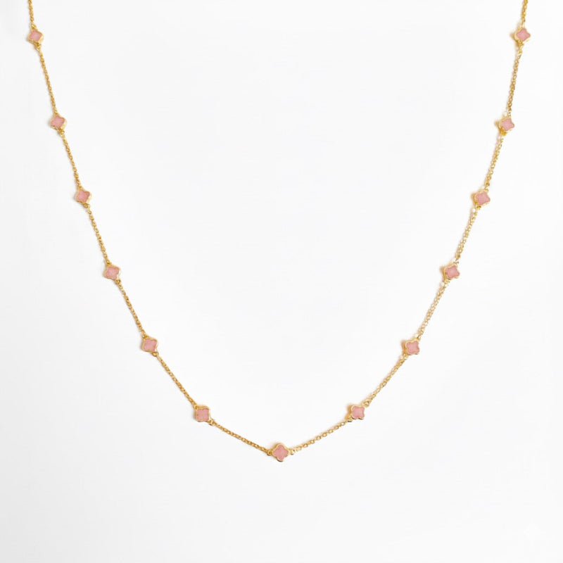 Gold-toned necklace featuring a delicate colored clover pendant, suspended on a fine chain for a soft pop of charm and color.
