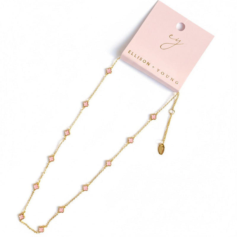 Gold-toned necklace featuring a delicate colored clover pendant, suspended on a fine chain for a soft pop of charm and color.