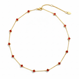 Gold-toned necklace featuring a delicate colored clover pendant, suspended on a fine chain for a soft pop of charm and color.