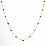 Gold-toned necklace featuring a delicate colored clover pendant, suspended on a fine chain for a soft pop of charm and color.