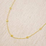 Delicate gold-tone necklace featuring evenly spaced petite chain links for a minimal and elegant look.