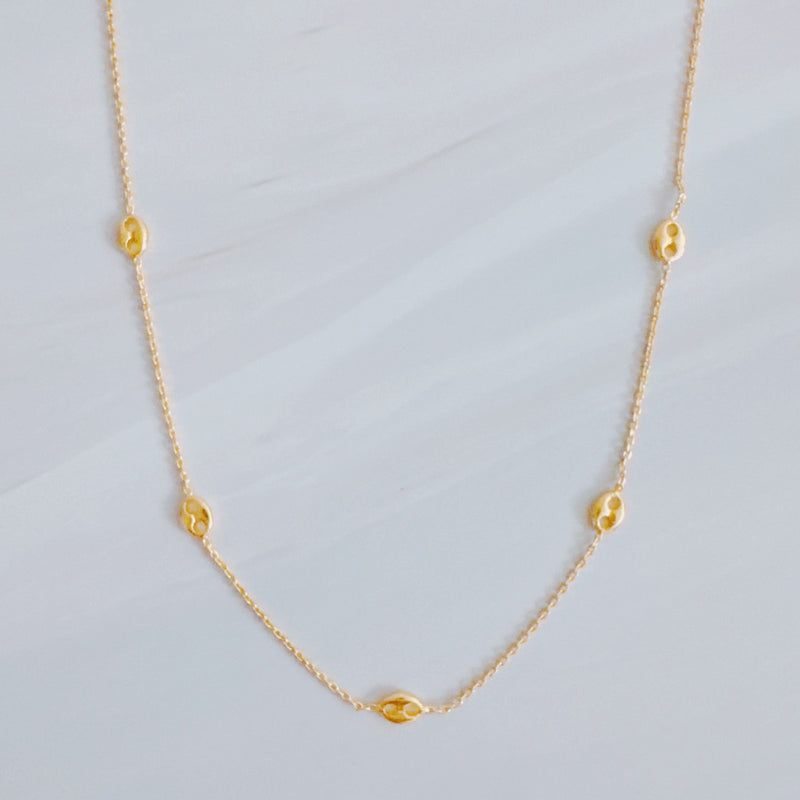 Delicate gold-tone necklace featuring evenly spaced petite chain links for a minimal and elegant look.