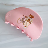 Preppy-inspired bear hair claw clips featuring fashionable teddy bear dressed in vintage collegiate outfits. Each clip showcases a different bear character on a pastel background, adding a playful yet polished touch to any hairstyle.