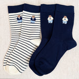 Set of cozy crew socks featuring charming preppy bear illustration in classic outfits, adding a playful and nostalgic touch to everyday wear.