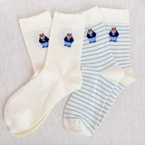 Set of cozy crew socks featuring charming preppy bear illustration in classic outfits, adding a playful and nostalgic touch to everyday wear.