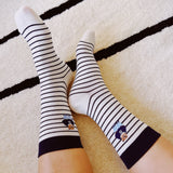 Set of cozy crew socks featuring charming preppy bear illustration in classic outfits, adding a playful and nostalgic touch to everyday wear.