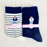 Set of cozy crew socks featuring charming preppy bear illustration in classic outfits, adding a playful and nostalgic touch to everyday wear.