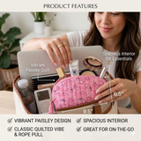 Woman holding a pink paisley makeup bag with product features highlighted