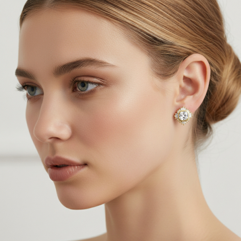 Gold-tone stud earrings featuring a radiant crown-like cluster of sparkling stones, arranged in a semi-circle to create a regal yet minimal look.