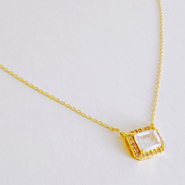 Dainty chain necklace featuring a radiant emerald-cut pendant in a classic prong setting, offering timeless elegance with a subtle touch of sparkle.