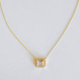Dainty chain necklace featuring a radiant emerald-cut pendant in a classic prong setting, offering timeless elegance with a subtle touch of sparkle.