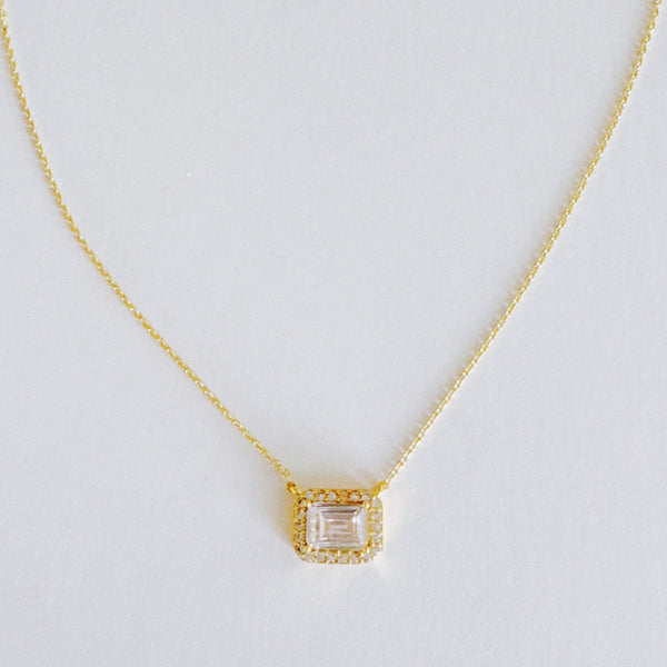 Dainty chain necklace featuring a radiant emerald-cut pendant in a classic prong setting, offering timeless elegance with a subtle touch of sparkle.