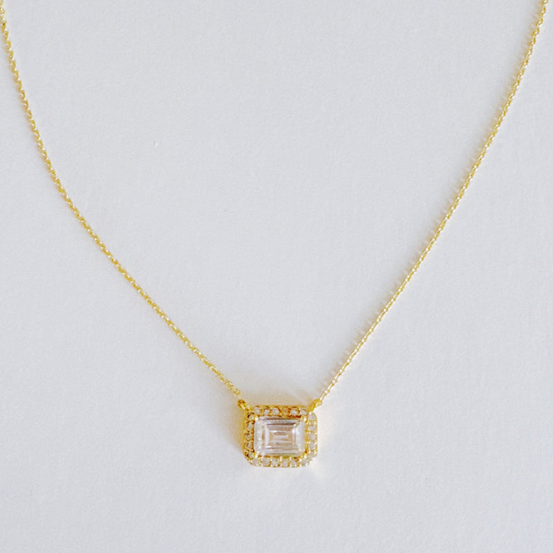 Dainty chain necklace featuring a radiant emerald-cut pendant in a classic prong setting, offering timeless elegance with a subtle touch of sparkle.