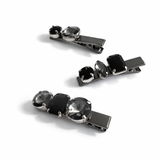 Three black and silver hair clips on a white background
