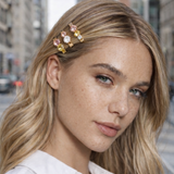 Woman with decorative hair pins in her blonde hair on a city street background