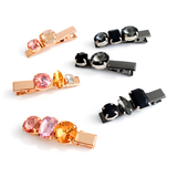 Set of colorful gemstone hair clips on a white background
