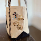 Set of two hexagon-shaped scarf magnetic brooch pins or earrings with a modern, abstract design. Each brooch features a sleek finish and sculptural angles, offering a stylish and functional accent for securing scarves or accessorizing garments.