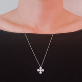 Silver cross pendant necklace featuring a symmetrical arrangement of radiant-cut cubic zirconia stones, creating a brilliant and elegant sparkle on a fine silver chain.