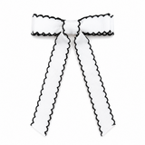 White hair bow with black trim on a white background