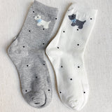 Crew-length socks featuring a charming Scottie dog pattern, designed in two coordinated colorways. The Scottie silhouettes are playfully on each sock, creating a fun and cozy look perfect for dog lovers and everyday wear.