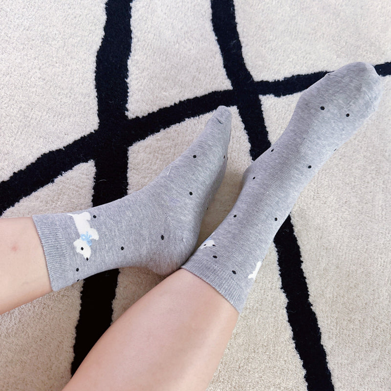 Crew-length socks featuring a charming Scottie dog pattern, designed in two coordinated colorways. The Scottie silhouettes are playfully on each sock, creating a fun and cozy look perfect for dog lovers and everyday wear.