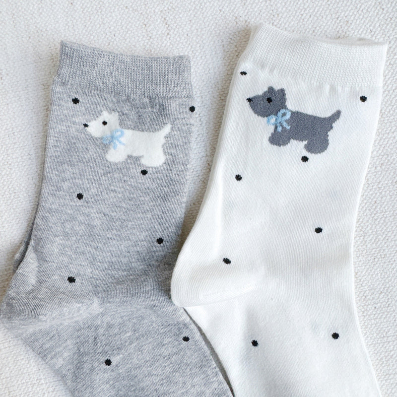 Crew-length socks featuring a charming Scottie dog pattern, designed in two coordinated colorways. The Scottie silhouettes are playfully on each sock, creating a fun and cozy look perfect for dog lovers and everyday wear.