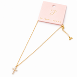 Gold necklace with small pendants on a pink Ellison & Young card