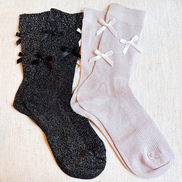 Set of two shimmer socks featuring delicate bow embellishments, designed in a chic, sparkly finish for a stylish and feminine touch.