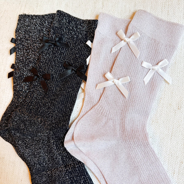 Set of two shimmer socks featuring delicate bow embellishments, designed in a chic, sparkly finish for a stylish and feminine touch.