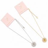 Two necklaces, one gold and one silver, on pink cards with 'Eloise Young' branding.