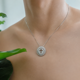 Necklace with a cross pendant on a person's neck, blurred background