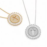 Two necklaces with circular pendants featuring crosses on a white background