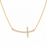 Gold necklace with a diamond-studded cross pendant on a white background