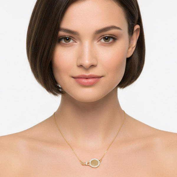 Chic and sporty necklace featuring a sideways-hanging tennis racket charm on a sleek chain. A playful accessory for tennis lovers, blending athletic flair with everyday style.