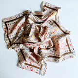 Elegant satin square scarf with a smooth, glossy finish—perfect for versatile styling as a hair accessory, neck tie, or bag accent.