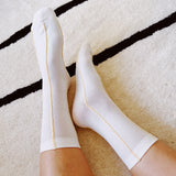 Set of two minimalist crew socks featuring subtle contrast stitching at the top and toe, adding a clean and stylish detail to everyday wear.