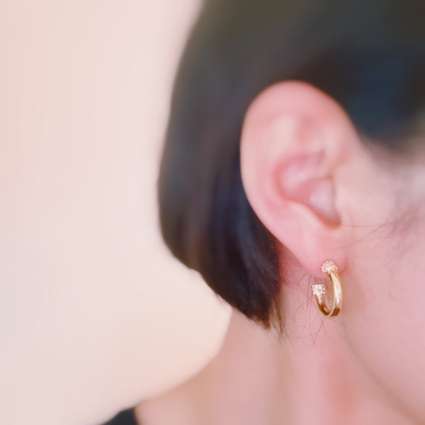 Minimalist gold-tone hoop earrings with a smooth, polished finish and classic round shape, perfect for everyday wear.