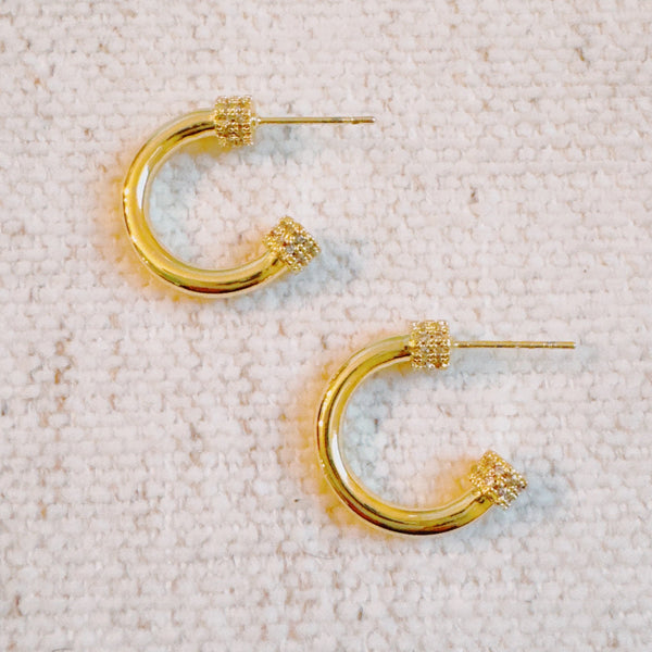 Minimalist gold-tone hoop earrings with a smooth, polished finish and classic round shape, perfect for everyday wear.