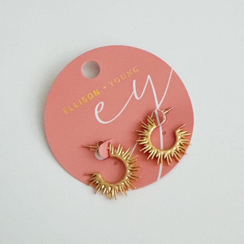 Set of small hoop earrings with radiating sunburst-inspired design in gold finishes