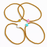 Beaded gold bracelet featuring a small polished cross charm centered. The So Very Blessed Cross Bracelet offers a meaningful, minimalist design perfect for everyday wear or gifting.