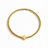 Beaded gold bracelet featuring a small polished cross charm centered. The So Very Blessed Cross Bracelet offers a meaningful, minimalist design perfect for everyday wear or gifting.