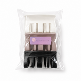 Hair clip in clear packaging with a visible brand label on a white background