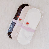 Set of three low cut socks featuring playful strawberry-themed patterns in soft pastel tones, designed for comfort and everyday charm.