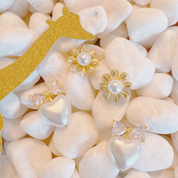 Set of two pearl earrings featuring playful sunny-side-up egg and classic pearl designs, combining whimsy with elegance.