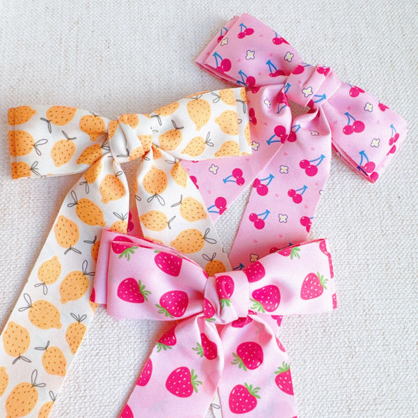 Colorful hair clip featuring a playful fruit print with lemons, strawberries, and cherries—adding a fun, fresh pop to any hairstyle.