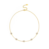 Gold necklace with small stones on a white background